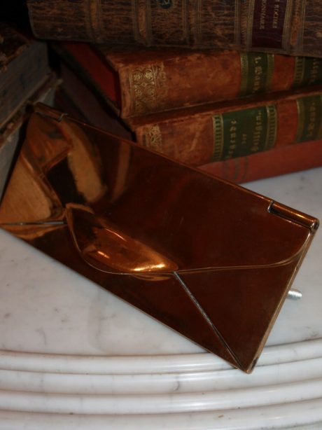 An English brass letter box (1891) in the shape of an envelope.