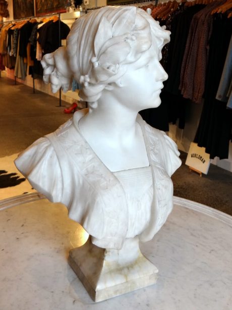 Signed marble bust of young woman with laurel crown