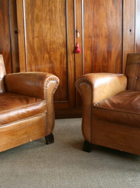 Pair of leather club chairs with panelled backs c.1950