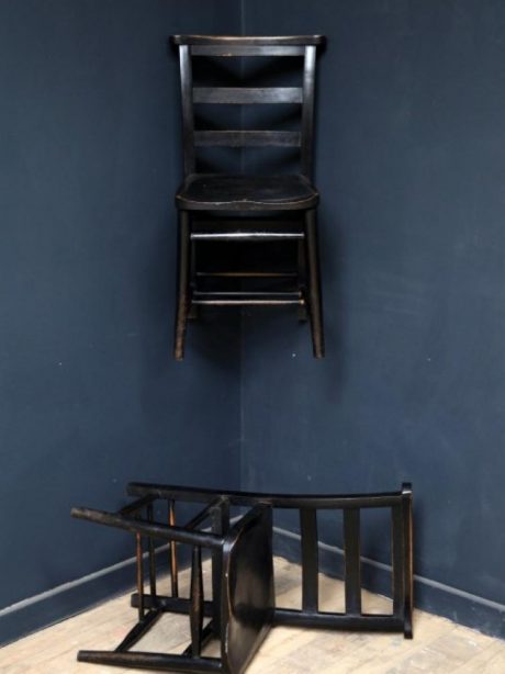 A run of ten English ladder back ebonised chapel chairs c.1910