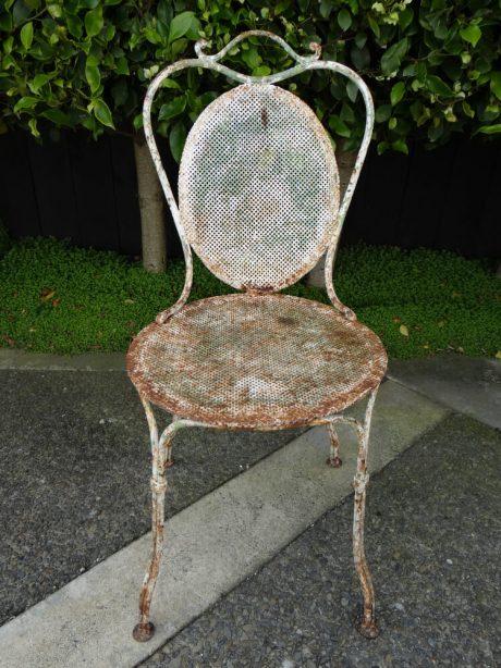 A pair of 19th century French pierced metal garden chairs