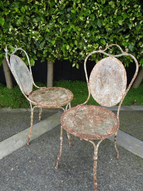 A pair of 19th century French pierced metal garden chairs