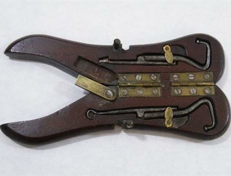 Antique mahogany cased pair of hinged boot pulls
