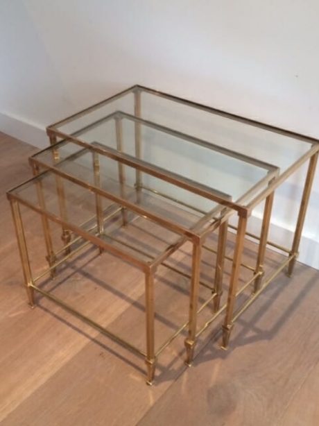A brass and glass trio nesting table likely by Jansen