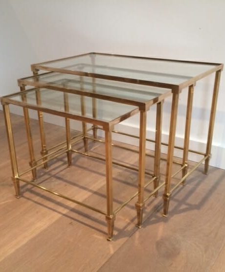 A brass and glass trio nesting table likely by Jansen