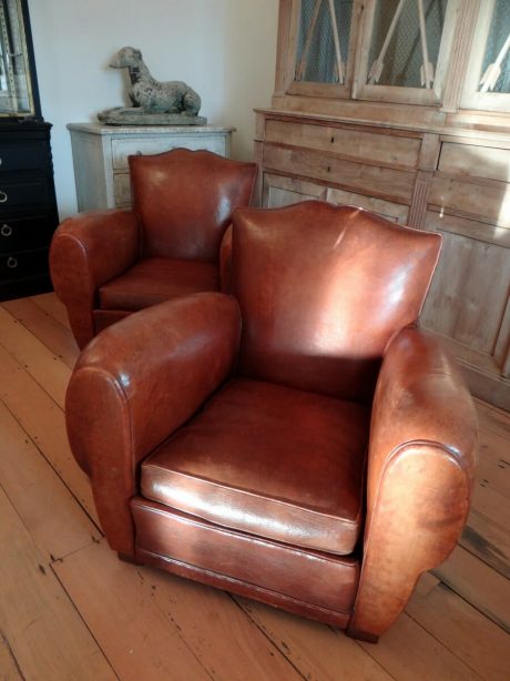 Pair of French 1920's moustache back leather club chairs