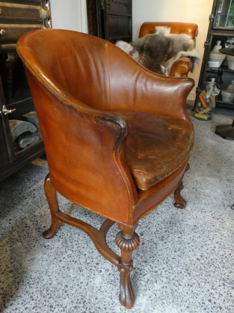 Edwardian leather tub chair on carved oak frame