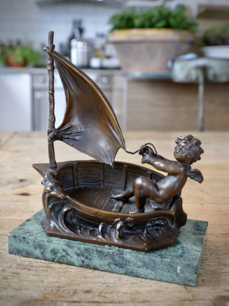Bronze sculpture of a putti in a sailing boat by Moreau