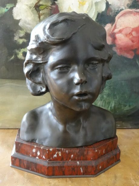 Bust of a young child cast in bronze signed Olest c.1920