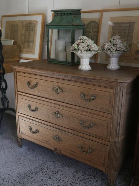 A late 18th century Louis XVI style bleached three drawer oak commode