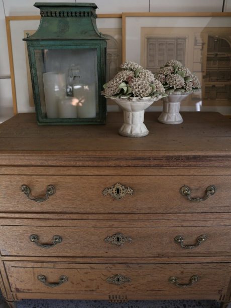 A late 18th century Louis XVI style bleached three drawer oak commode