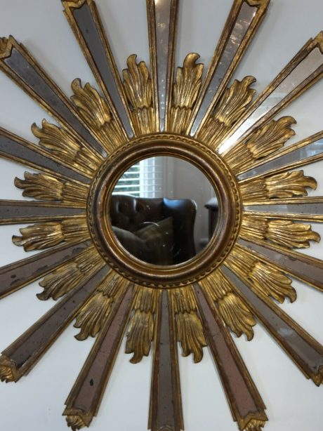 A mid 20th century large round carved and gilt sunburst mirror
