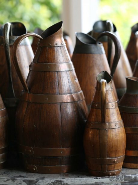 A collection of antique French oak staved wine or cider jugs