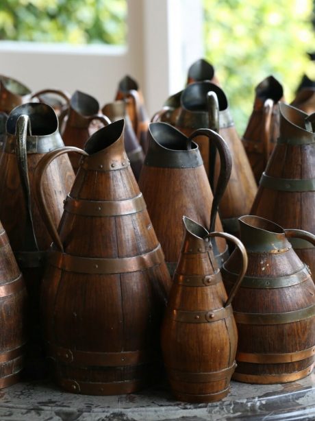 A collection of antique French oak staved wine or cider jugs