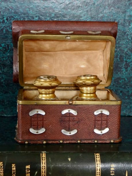 A pair of scent bottles in a leather and mother of pearl case