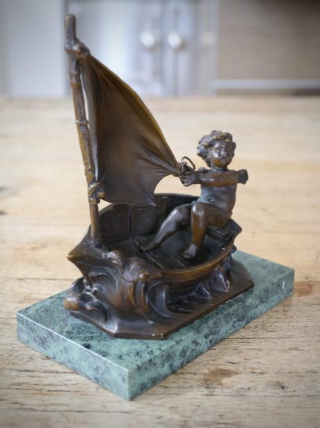 Bronze sculpture of a putti in a sailing boat by Moreau