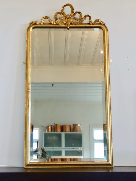 Antique French gilt bow crested bevelled mirror