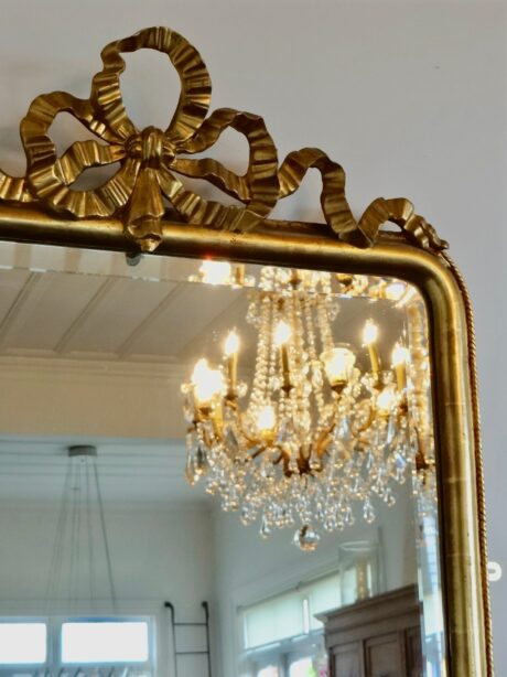Antique French gilt bow crested bevelled mirror