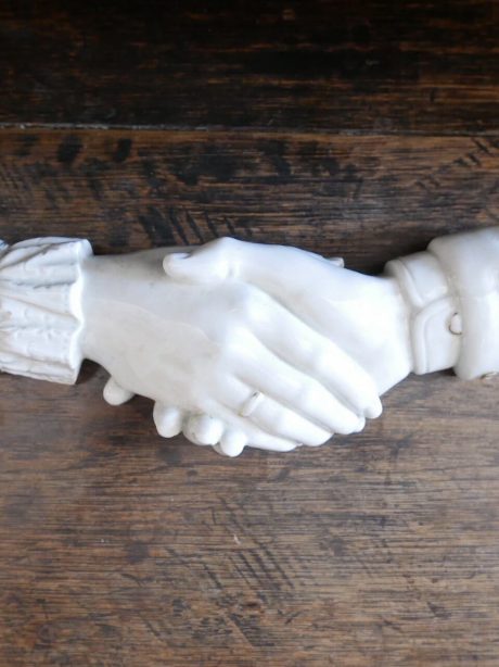 Late 19th century glazed ceramic clasped hand ornament