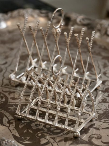 Silver plate toast racks with crossed Rifles and Golf clubs