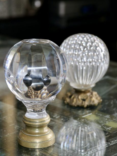 A pair of antique crystal boule newel posts