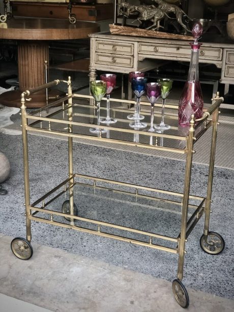 A mid-century Brass and Glass drinks trolley on castors