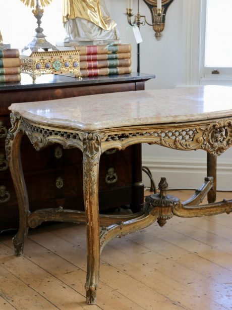 An antique French giltwood serpentine centre table