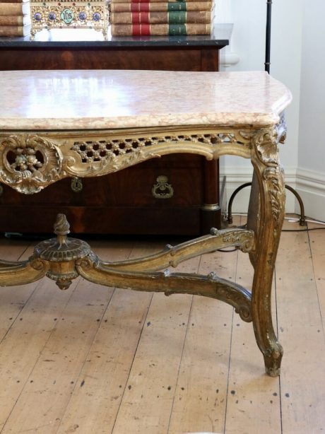 An antique French giltwood serpentine centre table