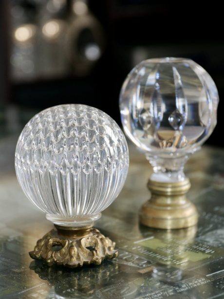 A pair of antique crystal boule newel posts