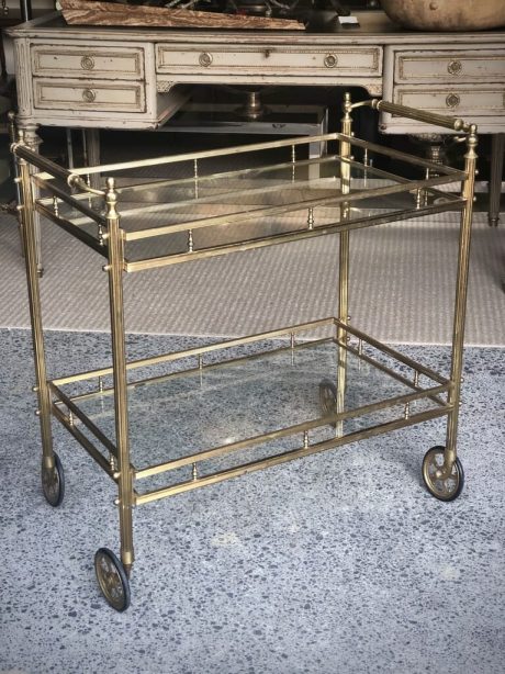 A mid-century Brass and Glass drinks trolley on castors
