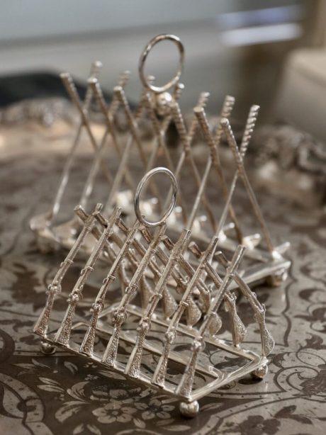 Silver plate toast racks with crossed Rifles and Golf clubs
