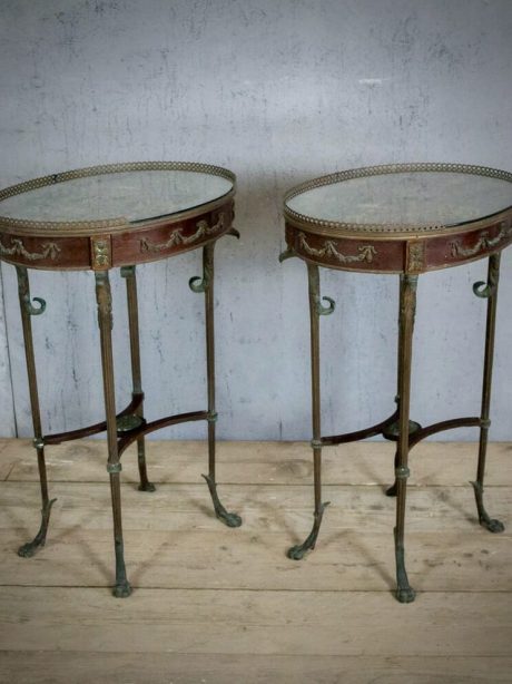 Matching pair of oval antique bronze legged side tables