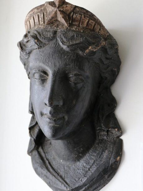 An Antique ebonised hand carved head of Diana