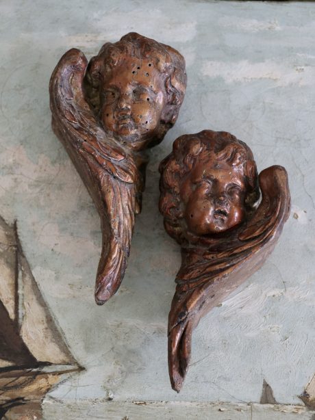 A decorative antique pair of cherub heads