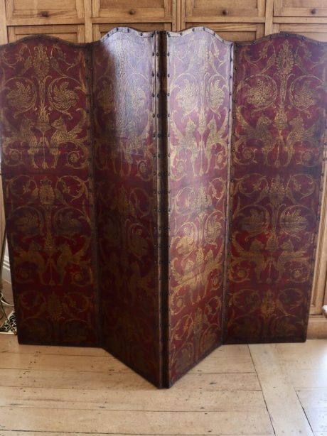 A 19th century double sided leather four panel screen