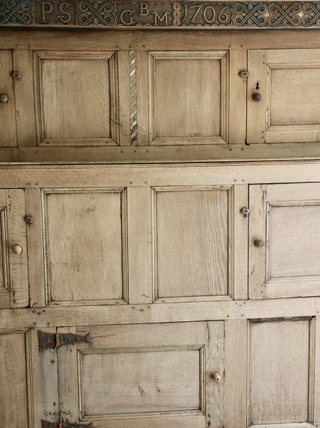 A large bleached oak westmoreland marriage cupboard dated 1706