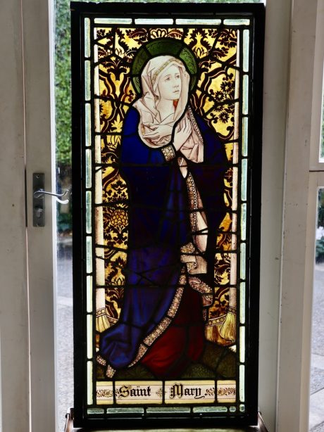 An antique stained glass panel of the Virgin Mary