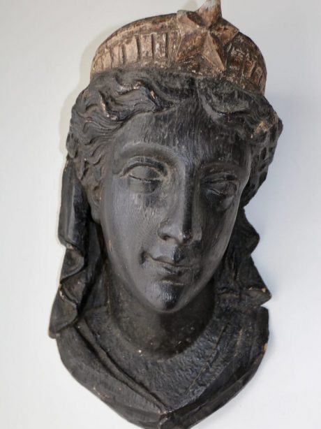 An Antique ebonised hand carved head of Diana