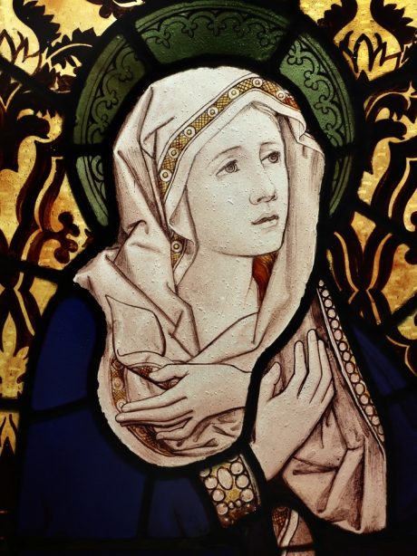 An antique stained glass panel of the Virgin Mary