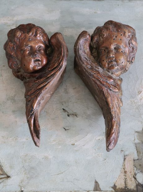 A decorative antique pair of cherub heads