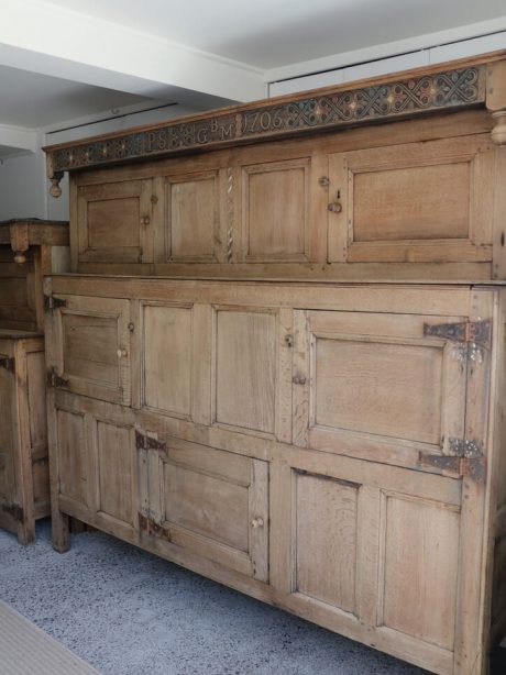 A large bleached oak westmoreland marriage cupboard dated 1706