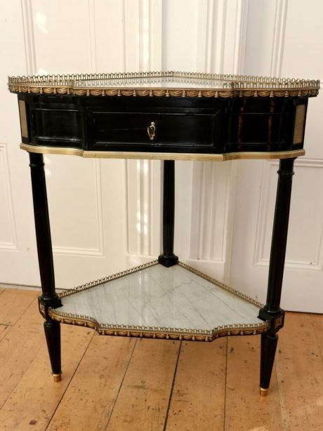 A French mid century Louis XVI style corner ebonised console