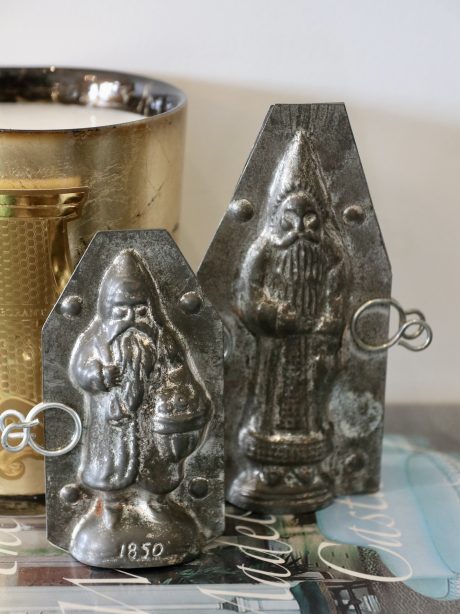 A pair of antique tin Santa chocolate moulds