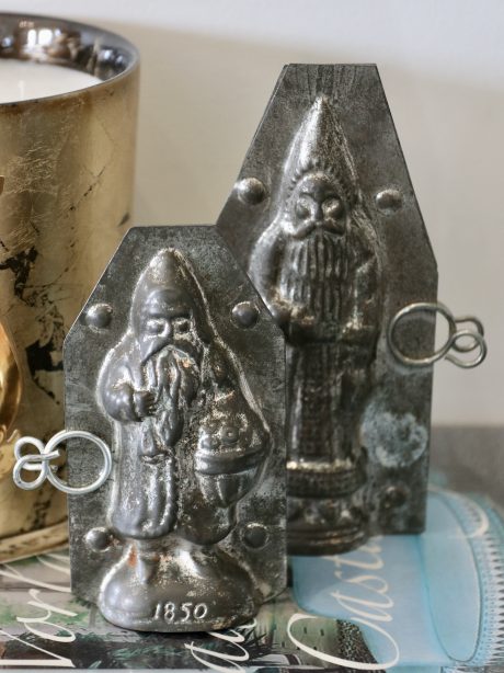 A pair of antique tin Santa chocolate moulds