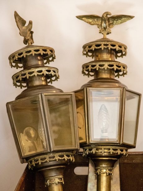 A pair of Antique brass coach lamps with eagle finials c.1900