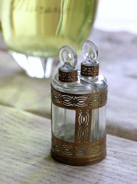 An antique double perfume kit in brass holder