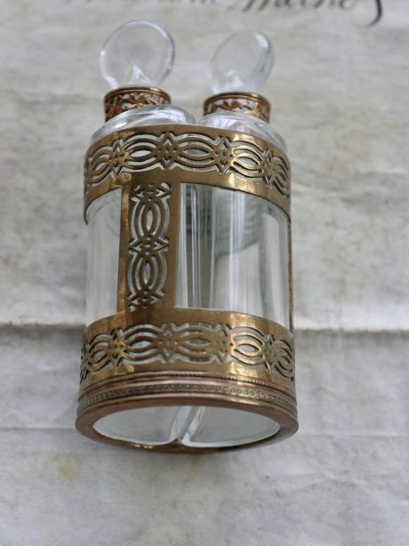 An antique double perfume kit in brass holder
